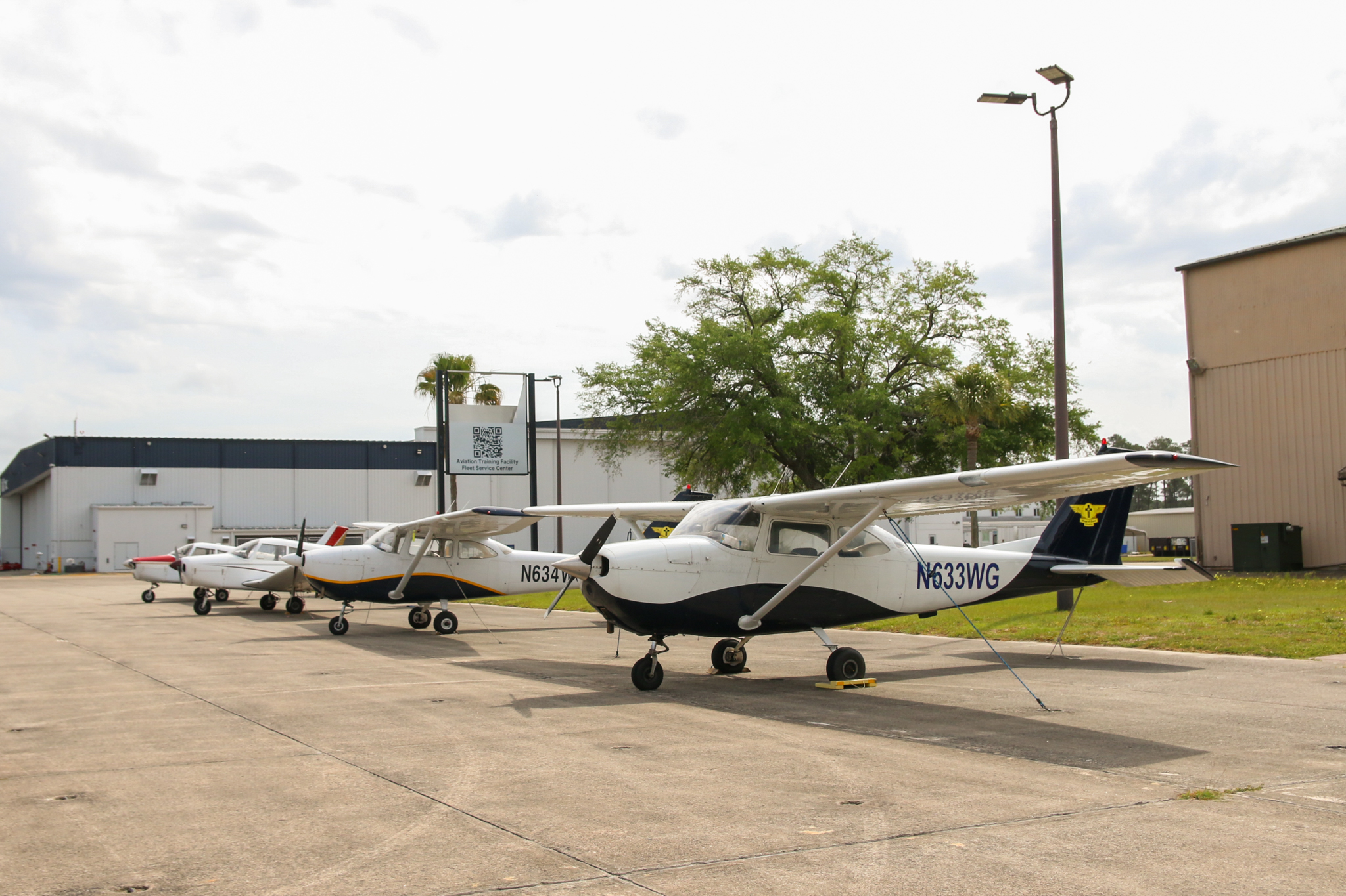 Wings of Grace aviation students in front of a training aircraft