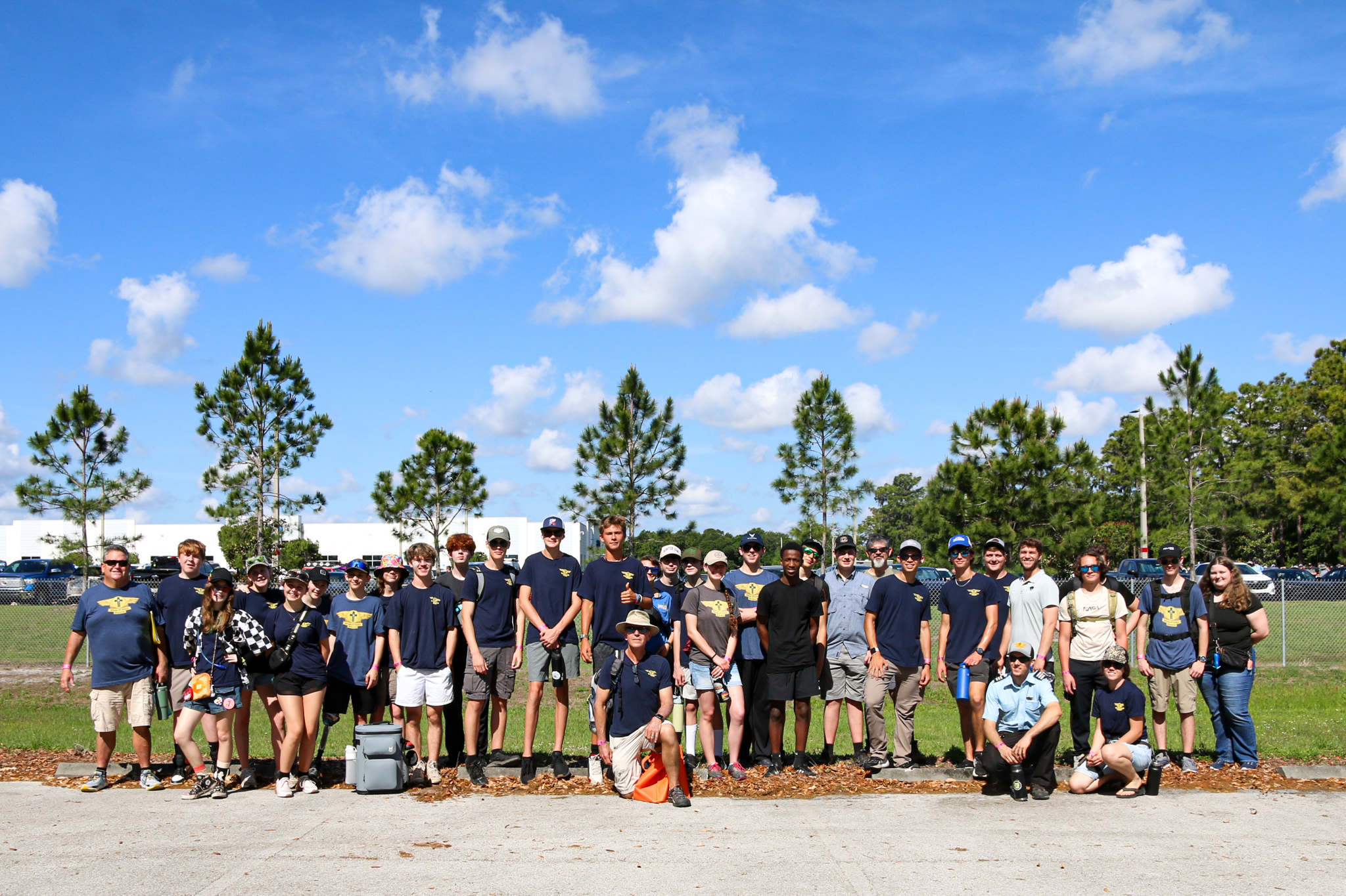 Wings of Grace teen aviation participants gathered in the hangar