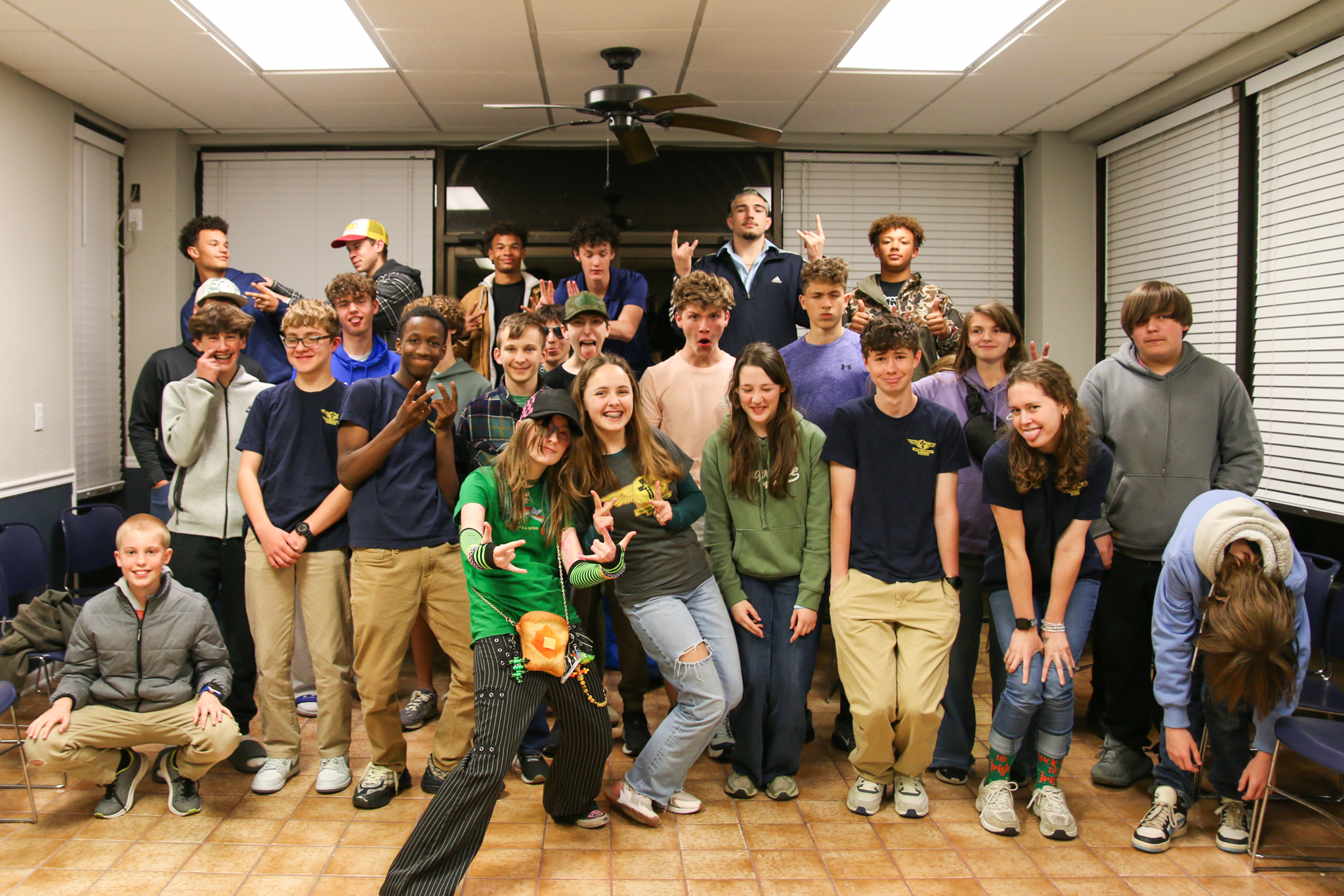 Wings of Grace youth group standing together at the aviation hangar